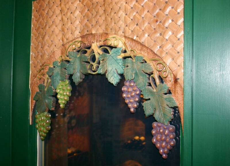 Detail of carved wine cellar door with grape vines