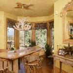 Log and pine dining table, carved sideboard and mirror.