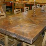 Recycled and reclaimed knotty pine wood from Wyoming snow fences created this impressive table that seats 16 guests. Massive log bases are the support. We can make one in any size to fit your dining room.