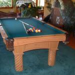 Carved knotty pine pool table