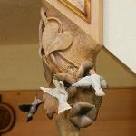 Handcarved hummingbirds at the bottom of a staircase newel post