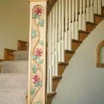 Handcarved newel post with wild rose vine and custom painting.