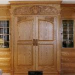 Solid oak entertainment center with basket weave and wild rose carving, leaded glass.