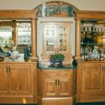 Media center with mirror and glass shelves, woodland scene carving, columns including solid wood and granite countertops