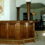 Cherry bar with solid brass foot rail, wood top and floor to ceiling columns