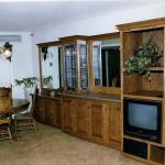 Oak entertainment center and built in cabinets with lighted stained glass display towers.