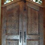 Distressed and gouged solid cherry double entry doors with stained glass transom