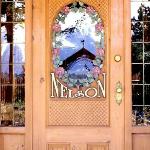 Customized entry door with basketweave, flowers and gold painted  lettering. Carvings inside and outside.