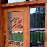 Carved door with sugar maple and mountain scene