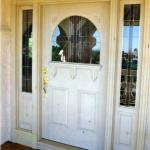Southwest style entry door with sidelights, stained and leaded glass and whitewash stain.