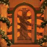 Custom carved door with stained glass. At night the light from inside is visible as a warm glow on the outside. Click next for the view from inside.