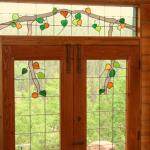 Aspen leaves and branches follow a theme throughout this house - leaded art glass, wire brushed and distressed finish on thick 2 1/4" knotty pine doors.