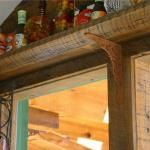 Reclaimed wood shelves above the windows are held up with rusted metal corbels